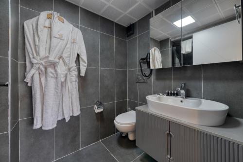 a bathroom with a sink and a toilet at Swans Hotel Old City Grand Bazaar in Istanbul