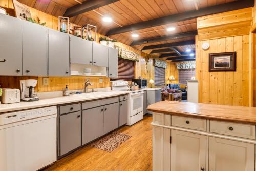 a kitchen with white cabinets and a wooden ceiling at Island Park Cabin Getaway Less Than 24 Mi to Yellowstone! in Rea