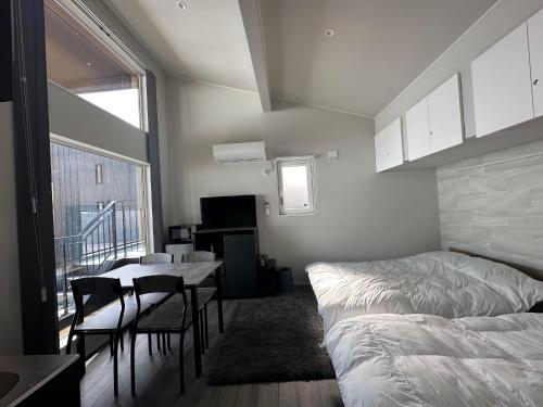 a bedroom with a bed and a table and chairs at Domaine Bless in Niki