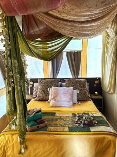 a bedroom with a large bed with a canopy at Ciriga Sicily Glamping in Santa Maria Del Focallo