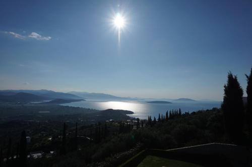 a view of a lake with the sun in the sky at Villa Artemis Nafplion in Tolo