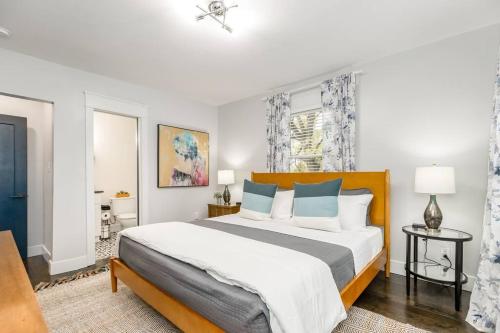 a bedroom with a large bed with blue pillows at Spacious 5BR/5.5BA Near Plaza & Museum in Kansas City