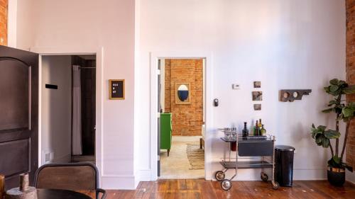 a room with a hallway with white walls and a table at Central Urban Flat - Near the Best of Covington in Covington