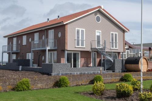 a house with a staircase in front of it at Residentie Oosterschelde in Sint Philipsland