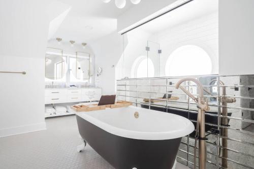 a bathroom with a black and white bath tub at Monastery Guest House in Mt Adams in Cincinnati