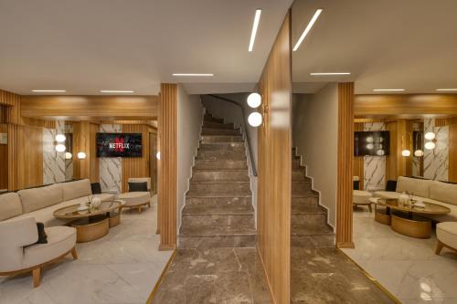 a staircase in a lobby with chairs and tables at Swans Hotel Old City Grand Bazaar in Istanbul