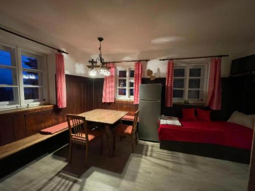 a kitchen with a table and a bed and a dining room at Egger's Sonnenhof Thurn in Thurn