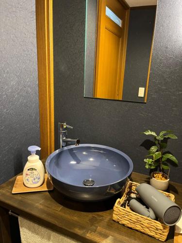 a bathroom sink with a large blue bowl at とれるの【TORERUNO】 in Takayama
