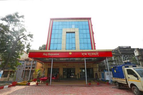 a building with a red sign in front of it at OYO Raj Rajeswari in Āsansol