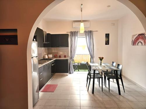 a kitchen and dining room with a table and chairs at Ruby Heaven Apartment in St Paul's Bay