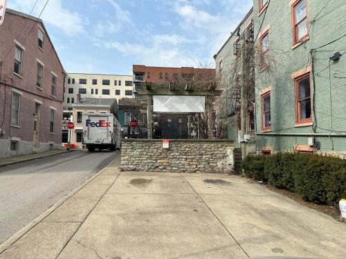 a truck driving down a street next to buildings at Main Street Oasis - with Parking in Covington