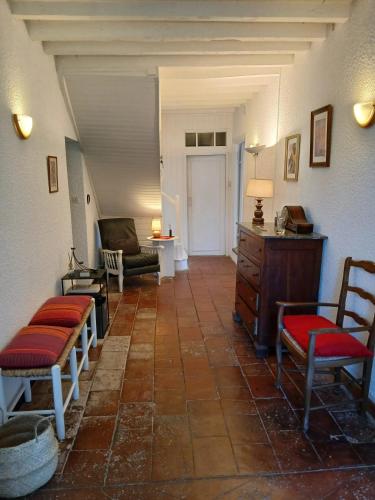 a living room with chairs and a couch and a table at Maison chaleureuse à Martisserre avec jardin privatif et cheminée in Martisserre