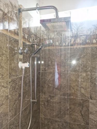 a shower in a bathroom with a glass door at Perivale in Moratuwa