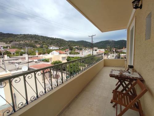 a balcony with a table and a view of a city at Απόλλων in Apóllona