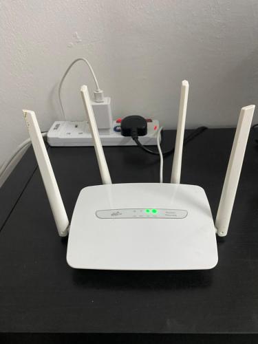 a white router sitting on top of a table at Rumah 2029 in Masjid Tanah