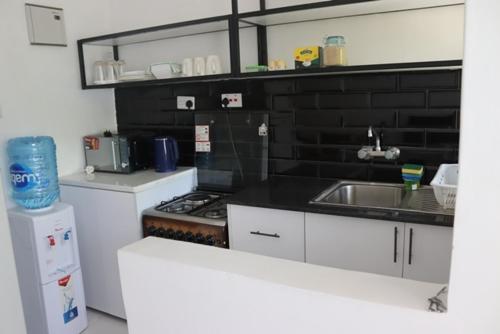 a small kitchen with a sink and a stove at Aisura place in Nairobi