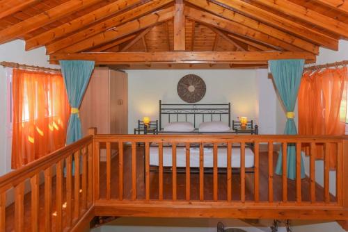 a bedroom with a bed with a wooden ceiling at Country house in Limnionas in Ayía Kiriakí
