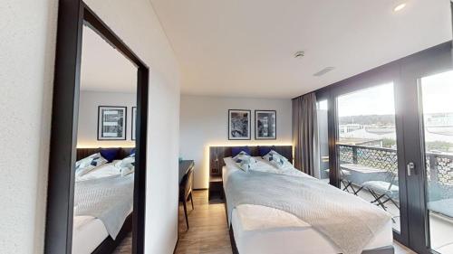 a bedroom with two beds and a mirror at Spacious 1 bedroom apartment with balcony in Zürich