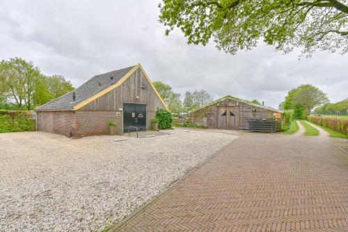 a barn and a barn house with a driveway at Pieterwagen in Sleen