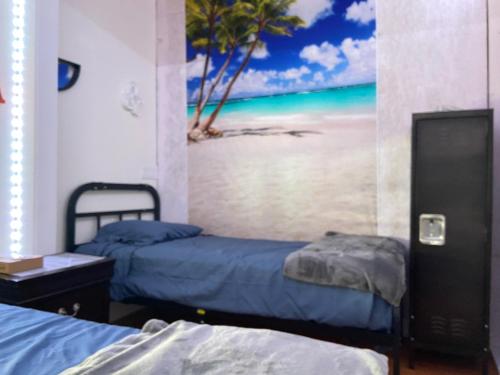 a room with two beds and a painting of a beach at Venice Beach International Traveler Cabins - Surf & Yoga & E-Bike in Los Angeles