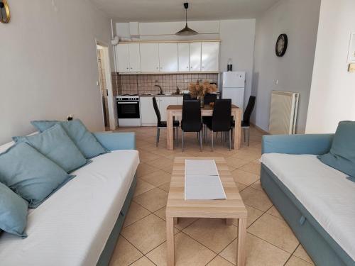a living room with a couch and a table at Philoxenia Apartments in Plataria
