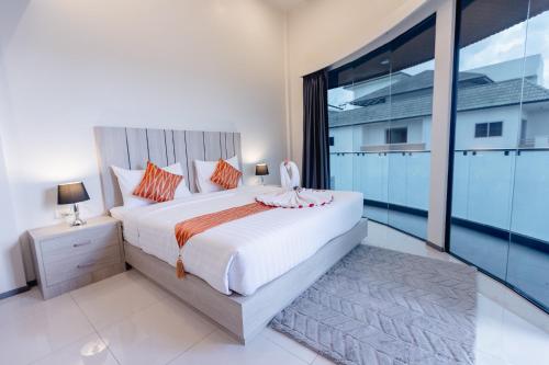 Ένα ή περισσότερα κρεβάτια σε δωμάτιο στο SUBANAN Residence Hatyai - ทรัพย์อนันต์ เรสซิเด้นซ์ หาดใหญ่