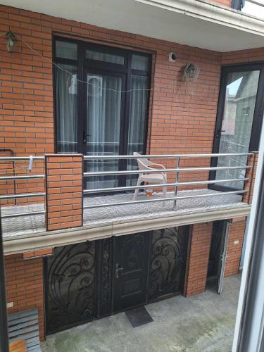 a balcony with a bench on a brick building at NINO in Kobuleti