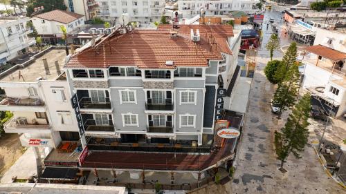 an overhead view of a white building with a red roof at Cihan Bey Otel Belek in Belek