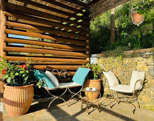 a patio with two chairs and a wooden pergola at Casa Paloma Private Villa in Cicerale