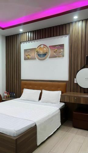 a bedroom with a bed and a purple lighting at Cường Thịnh Hotel in Na Dao Tổng