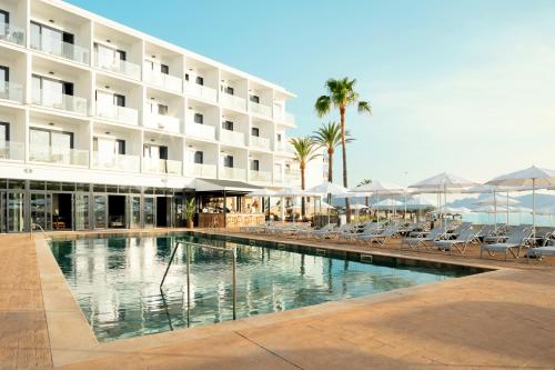 a hotel with a swimming pool in front of a building at Sunprime Pollensa Bay in Alcudia