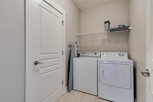 a white washer and dryer in a small kitchen at Lipstick & Boots 10 min to Broadway, Music Row, Fun in Nashville
