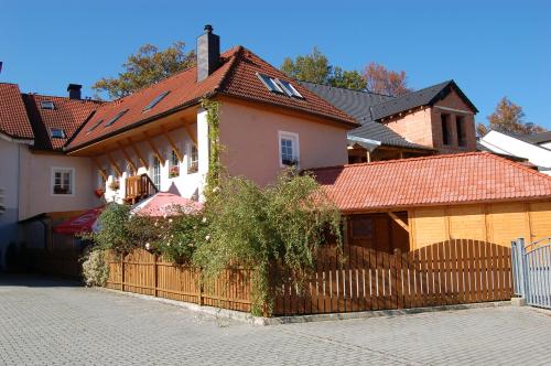 a house with a fence in front of it at Penzion Markus - Pivovar - Brewery Frymburk in Frymburk