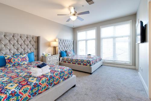 a bedroom with two beds and a ceiling fan at Pet Friendly Stylish Funky Central & Free Parking in Nashville