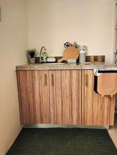 a kitchen with a counter top with a sink at Lazy Cabin PH in Manila