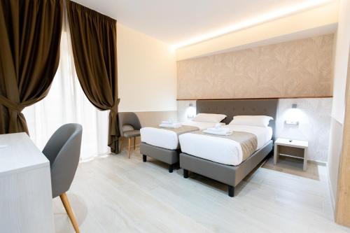 Postel nebo postele na pokoji v ubytování Hotel Maximus