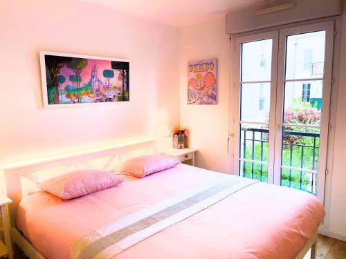 Ένα ή περισσότερα κρεβάτια σε δωμάτιο στο Appartement Magique à 1,5 km de Disneyland Paris