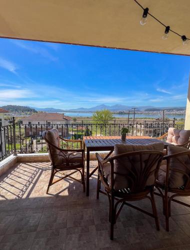 a patio with a table and chairs and a view at Lake House Ioannina in Ioannina