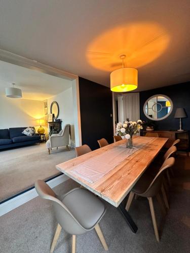 a dining room with a wooden table and chairs at Tower House, Cowes Old Town in Cowes