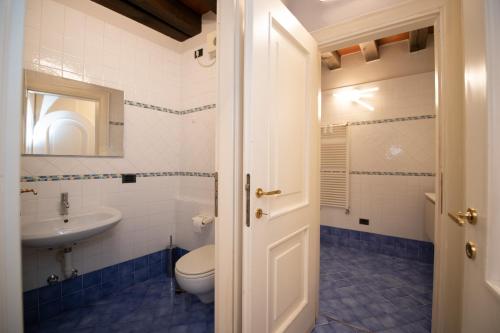 a bathroom with a toilet and a sink at Casa sul Porto in Desenzano del Garda