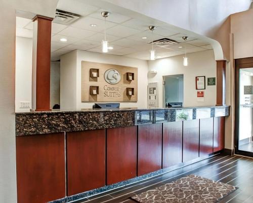 a hotel lobby with a large counter with a reception desk at Comfort Suites Lombard/Addison in Lombard