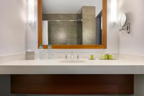 a bathroom with a sink and a mirror at The Legend Paracas Resort in Paracas