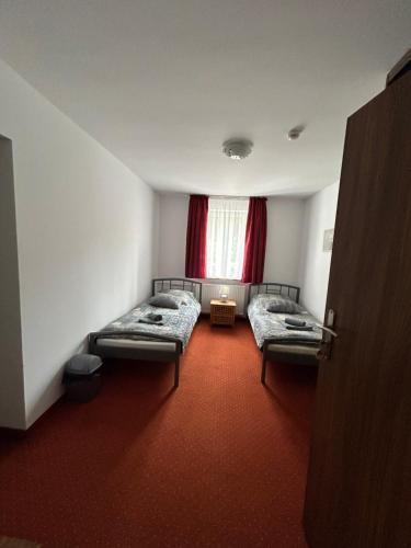 a room with two beds and a window at Leśny Dom in Barlinek