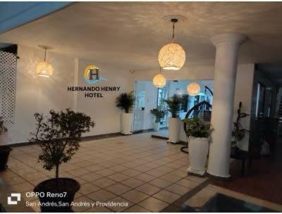 a lobby with potted plants in a building at HOTEL HERNANDO HENRY in San Andrés