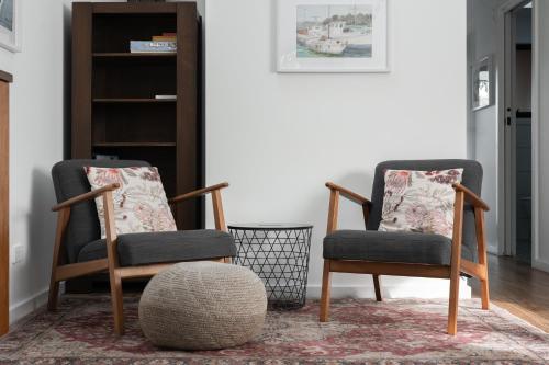 two chairs in a living room with a rug at Derby Bank House- Heritage listed two bedroom old school B&B suite or a self contained cabin in Derby