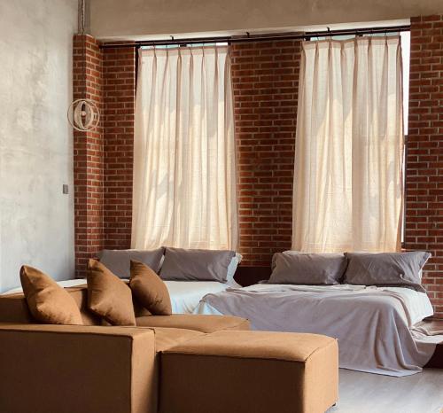a living room with two beds and a couch at BASED - Mersing in Mersing