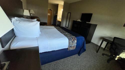 a hotel room with a bed and a desk at Garner INN & Suites in Garner