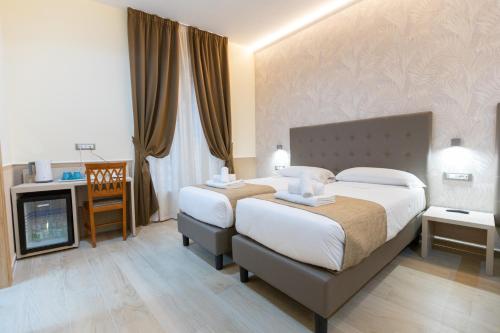 Postel nebo postele na pokoji v ubytování Hotel Maximus