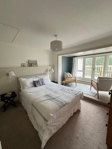 a bedroom with a large white bed and a window at Tower House, Cowes Old Town in Cowes