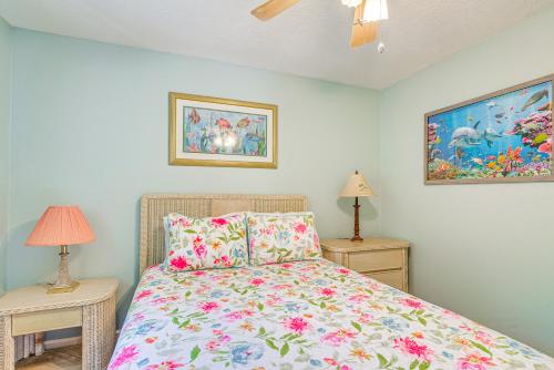 a bedroom with a bed and two tables with lamps at Lovely Crystal River Home with Lanai and Pool! in Crystal River